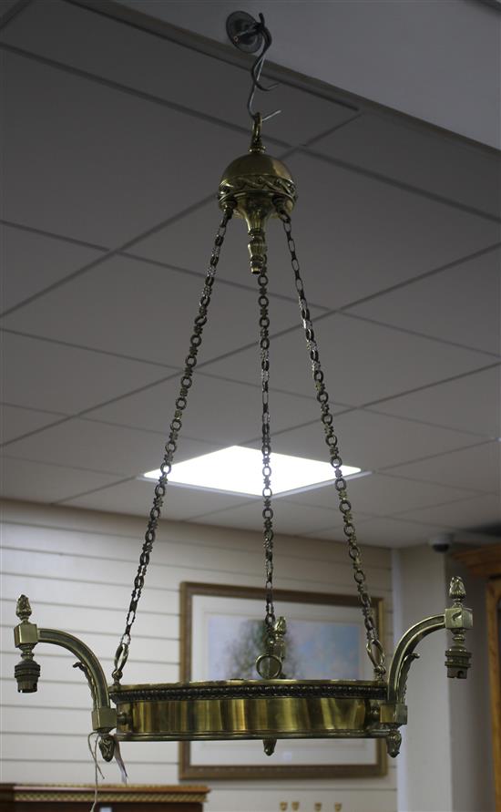 An Edwardian brass light fitting, made for electricity, lacking shade, drop 94cm, diameter 56cm